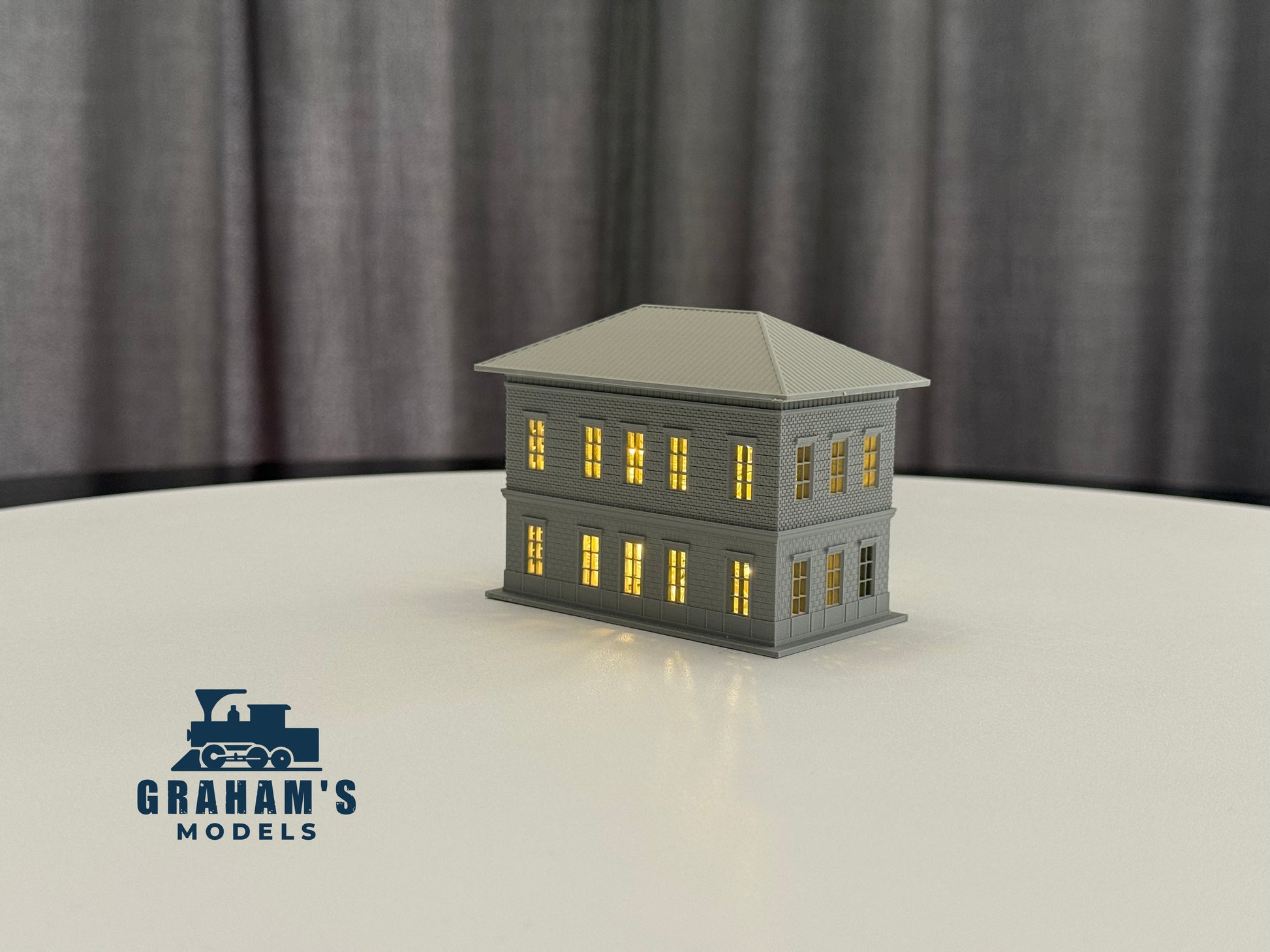 Small N scale train station model by Graham’s Models, fully assembled, featuring detailed platform and station building for model railroads.