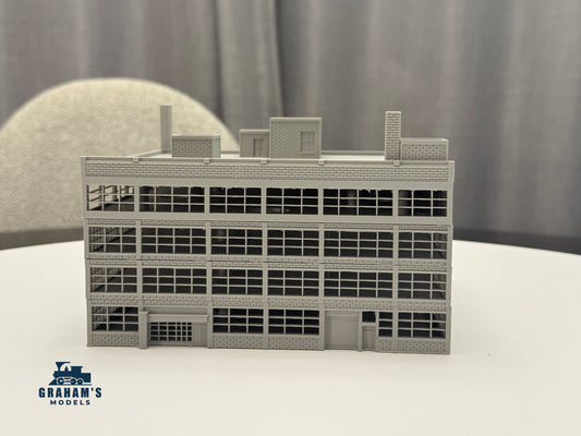 N scale modular warehouse by Graham’s Models with stackable levels, assembled, detailed structure for model train layouts.
