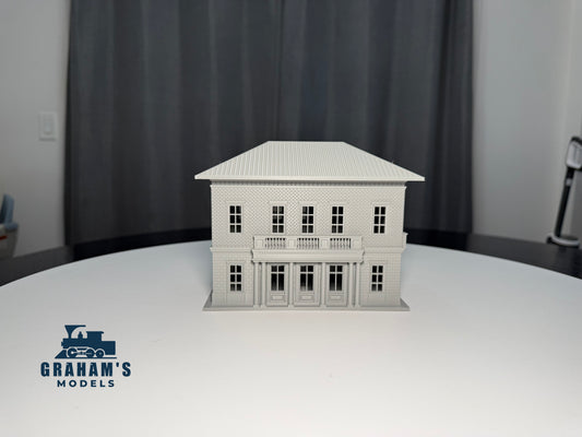 HO scale small train station by Graham’s Models, built and assembled, featuring detailed platform and station building with signage.