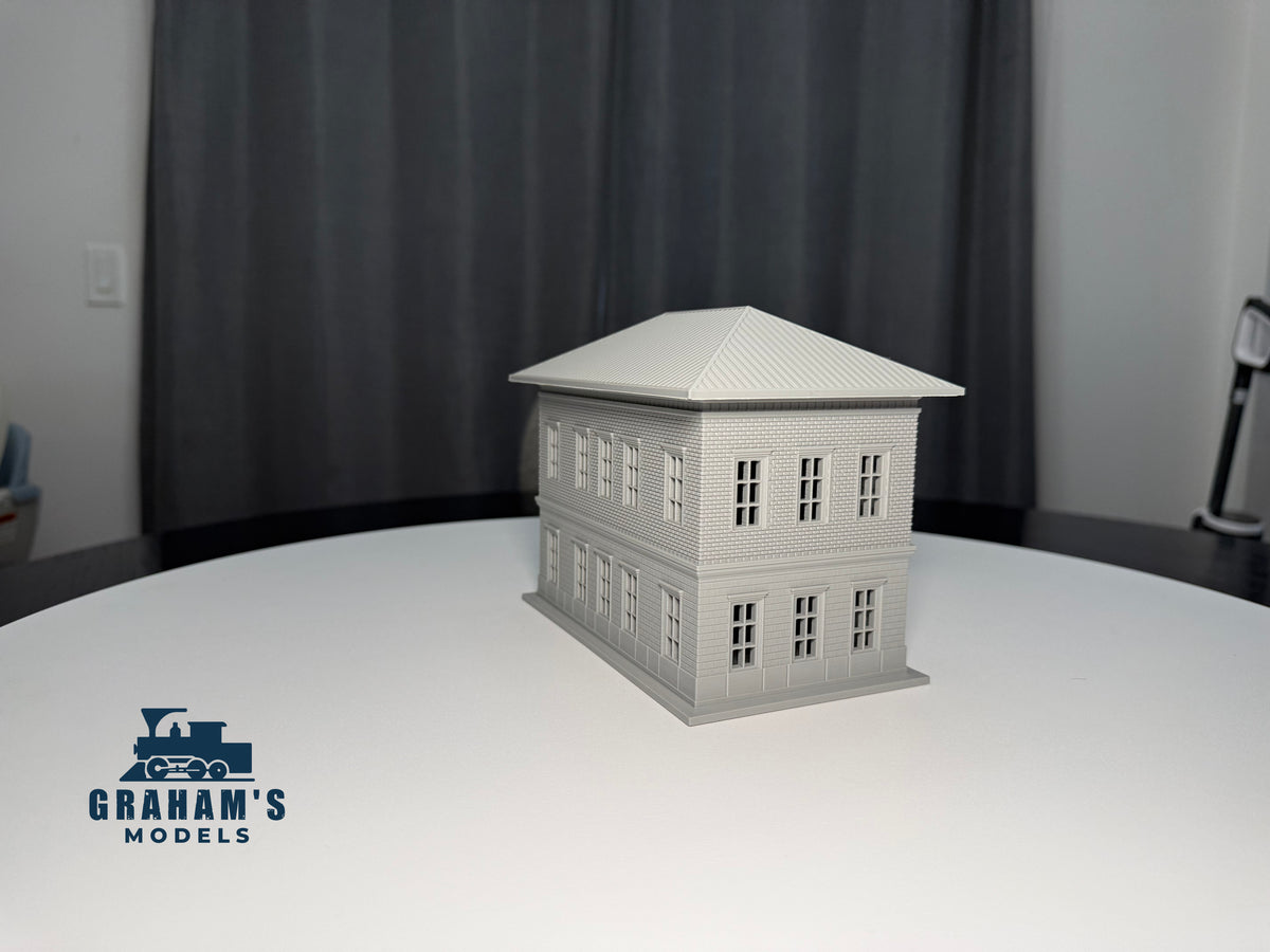 Small HO scale train station built and assembled by Graham’s Models, featuring detailed architecture and realistic design.