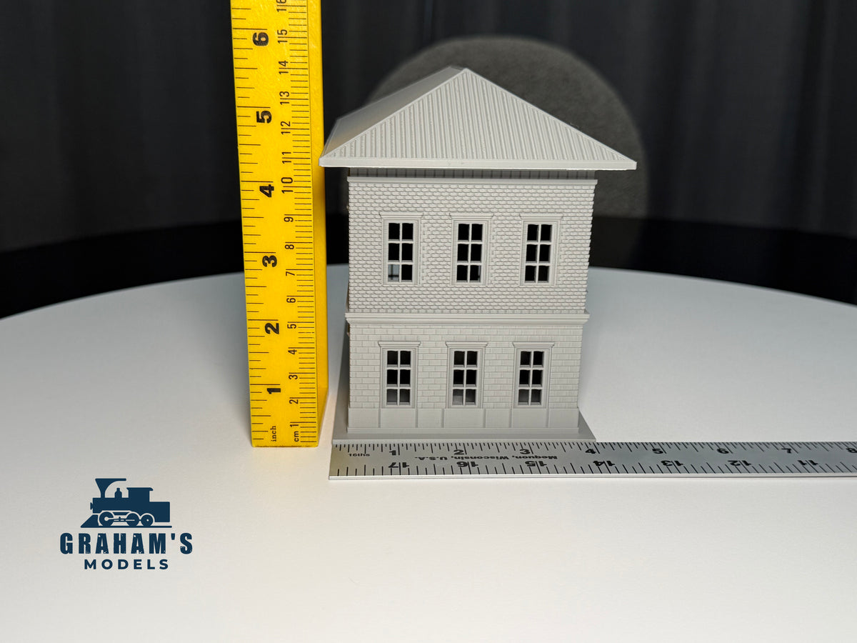 HO scale small train station model by Graham’s Models, built and assembled, featuring detailed platform and station building.